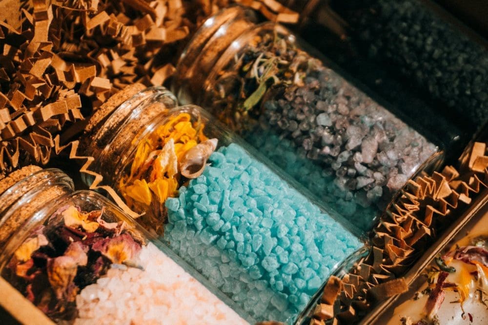 clear glass jars full of colored stones
