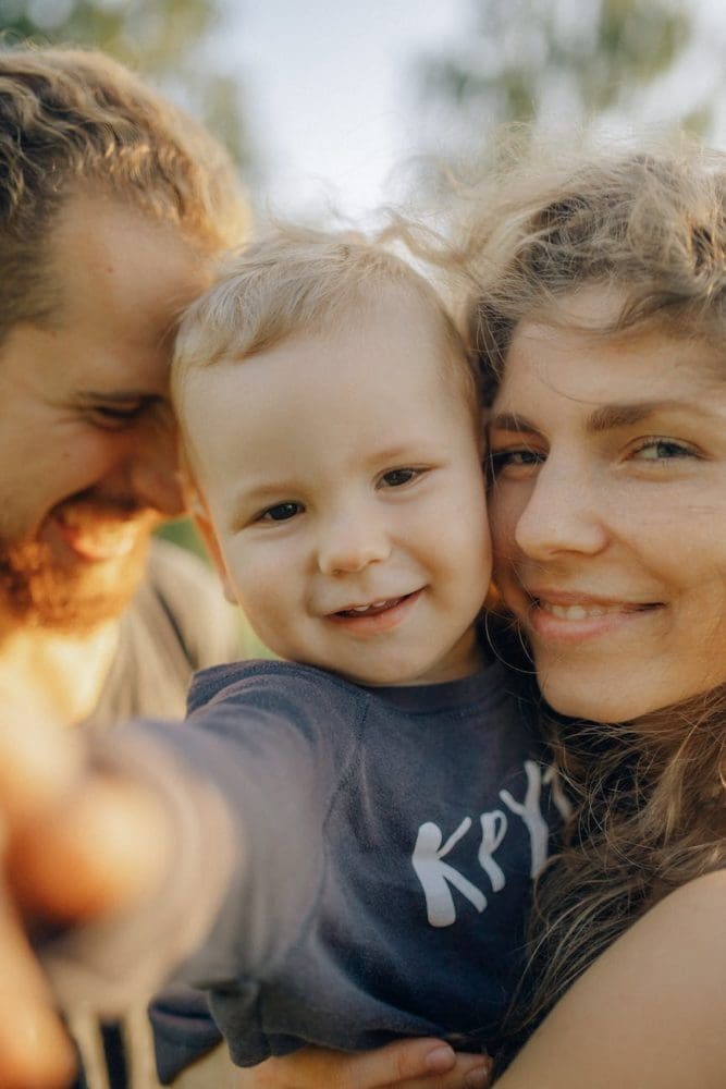 smiling parents with their adorable child